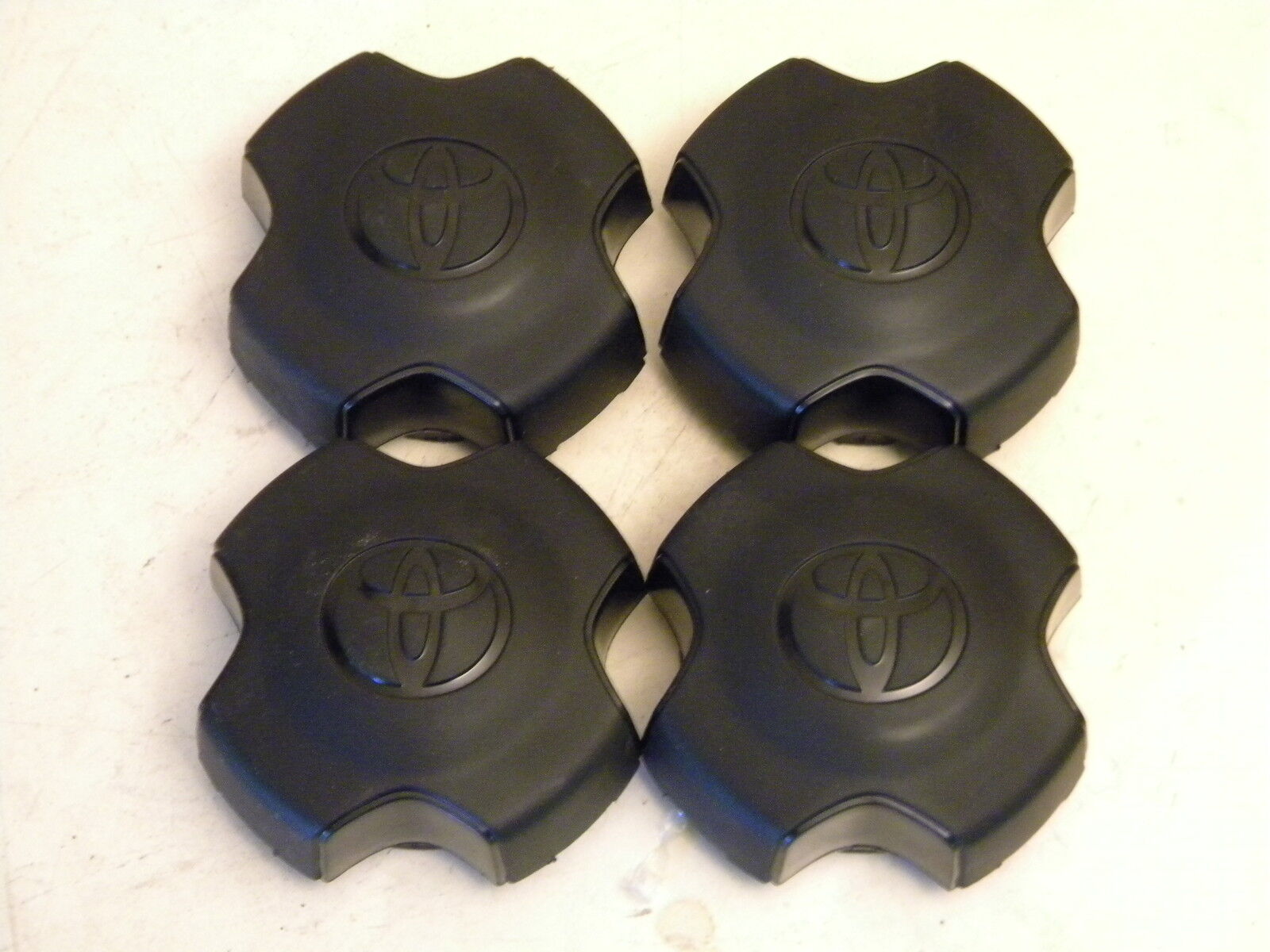 (4) 1993-2002 Toyota Corolla Tercel wheel center caps black  NOS (New old stock)